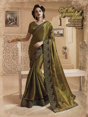 New And Unique Shade In Green Is Here With This Designer Olive Green Colored Saree Paired With Olive Green Colored Blouse. This Saree And Blouse Are Fancy Silk Fabricated Beautified With Heavy Embroidered Lace Border. 