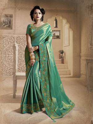You Will Definitely Earn Lots Of Compliments Wearing This Designer Saree In Sea Green Color. This Saree And Blouse Are Fancy Silk Based Beautified With Heavy Embroidered Lace Border. Buy Now.