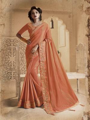 A Must Have Shade In Every Womens Wardrobe Is Here With This Designer Peach Colored Saree Paired With Peach Colored Blouse. This Saree And Blouse Are Fancy Silk Based Beautified With Heavy Embroidered Lace Border. 