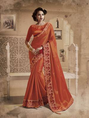 Shine Bright Wearing This Beautiful Heavy Designer Saree In Orange Color Paired With Orange Colored Blouse. This Saree And Blouse Are Fancy Silk Based Bautified With Heavy Embroidered Lace Border. 