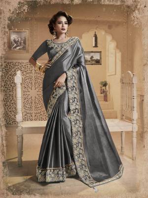 Flaunt Your Rich And Elegant Taste Wearing This Designer Fancy Silk Based Saree In Grey Color Paired With Grey Colored Blouse. This Saree Will Earn You Lots Of Compliments From Onlookers. Buy Now.