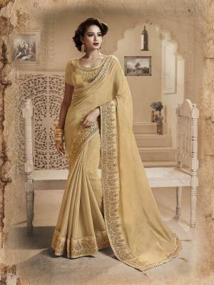You Will Definitely Earn Lots Of Compliments Wearing This Designer Saree In Beige Color. This Saree And Blouse Are Fancy Silk Based Beautified With Heavy Embroidered Lace Border. Buy Now.