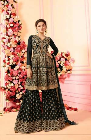 Grab This Beautiful Designer Sharara Suit For This Festive And Wedding Season. Its Top, Bottom And Dupatta Are In Black Color. Its Top And Bottom Are Georgette Based With Heavy Embroidery Paired With Chiffon Fabricated Dupatta. Buy This Dress Now.