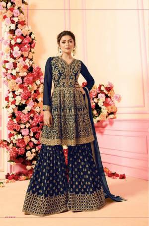 Grab This Beautiful Designer Sharara Suit For This Festive And Wedding Season. Its Top, Bottom And Dupatta Are In Navy Blue Color. Its Top And Bottom Are Georgette Based With Heavy Embroidery Paired With Chiffon Fabricated Dupatta. Buy This Dress Now.
