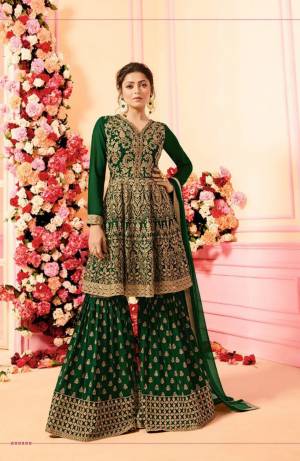 Grab This Beautiful Designer Sharara Suit For This Festive And Wedding Season. Its Top, Bottom And Dupatta Are In Dark Green Color. Its Top And Bottom Are Georgette Based With Heavy Embroidery Paired With Chiffon Fabricated Dupatta. Buy This Dress Now.