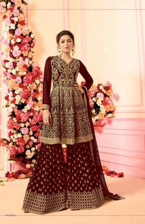 Grab This Beautiful Designer Sharara Suit For This Festive And Wedding Season. Its Top, Bottom And Dupatta Are In Maroon Color. Its Top And Bottom Are Georgette Based With Heavy Embroidery Paired With Chiffon Fabricated Dupatta. Buy This Dress Now.