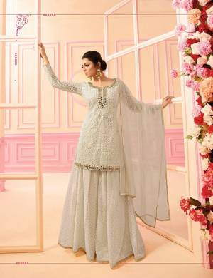 Here Is A Beautiful Indo-Western Dress In Subtle Shades. Its Top, Bottom And Dupatta Are In Pretty Off-White Color. It Is Fabricated On Georgette Paired with Chiffon Dupatta. Buy This Designer Indo-Western Dress Now. 