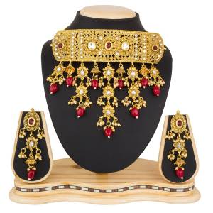 Grab This Beautiful And Attractive Looking Heavy Choker Necklace Set In Golden Color Paired With Heavy Earrings Set. This Set Is Beautified With Stone And Moti Work. It Can Be Paired With Any Colored Traditional Attire. Buy Now.