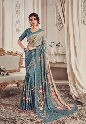 Flaunt Your Rich And Elegant Taste Wearing This Beautiful Saree In Grey And Steel Blue Color Paired With Steel Blue Colored Blouse. This Saree And Blouse Are Georgette Based Beautified With Prints. 