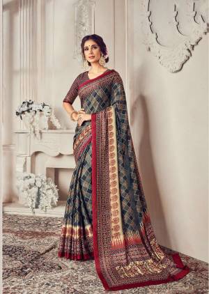 This Festive Season, Look Beautiful And Be Comfortable Wearing This Saree In Navy Blue Color Paired With Contrasting Maroon Colored Blouse. This Saree And Blouse Are Georgette Based Beautified With Prints All Over. 