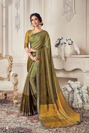 New Shade Is Here To Add Into Your Wardrobe With This Saree In Olive Green Color Paired With Yellow and Green Colored Blouse. This Saree Is Light Weight And Easy To Carry All Day Long. 