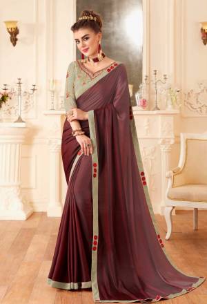 You Will Definitely Earn Lots Of Compliments Wearing This Lovely Color Pallete With This Designer Saree In Wine Color Paired With Contrasting Grey Colored Blouse. This Saree Is Fabricated On Soft Silk Paired With Art Silk Fabricated Blouse.