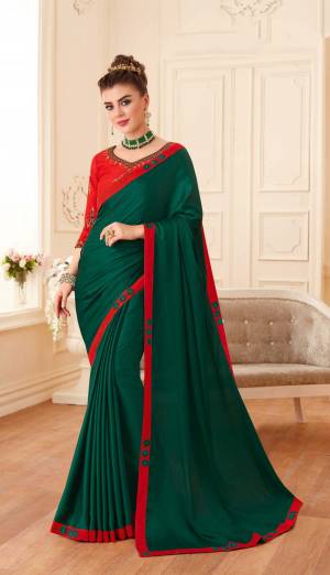 New Shade Is Here In Green With This Designer Saree In Pine Green Color Paired With Contrasting Red Colored Blouse. This Saree And Blouse Are Silk Based Beautified With Embroidery Over The Blouse And Lace Border. 
