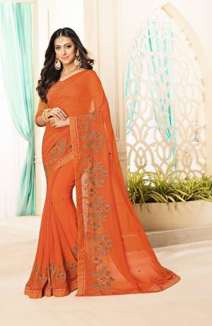 Celebrate This Festive Season Wearing This Bright Orange Colored Saree Paired With Orange Colored Blouse. This Saree Is Fabricated On Georgette Paired With Brocade Fabricated Blouse. Grab This Now.