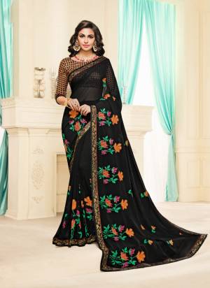 For A Bold and Beautiful Look, Grab This Designer Saree In Black Color Paired With Multi Colored Blouse. This Saree Is Fabricated On Georgette Paired With Brocade Fabricated Blouse. Buy This Designer Saree Now.