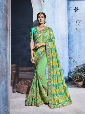 Celebrate This Festive Season Wearing This Designer Saree In Light Green Color Paired With Sea Green Colored Blouse. This Silk Based Saree Gives A Rich Look To Your Personality. Buy Now.