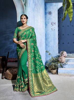 Celebrate This Festive Season Wearing This Designer Saree In Dark Green Color Paired With Dark Green Colored Blouse. This Silk Based Saree Gives A Rich Look To Your Personality. Buy Now.