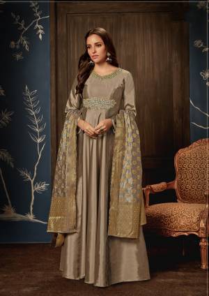 Flaut Your Rich And Elegant Taste In This Subtle Color With This Designer Readymade Gown In Grey Color Paired With Grey Colored Dupatta. This Silk Based Dress Has Hand Embroidered Patch Work With Jacquard Silk Dupatta. 