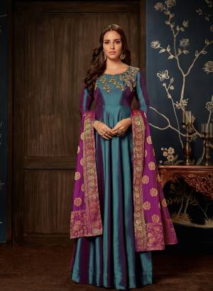 Go Coloful With This Two Tone Readymade Gown In Blue color Paired With Purple Colored Dupatta. This Gown And Dupatta Are Silk Based Which Gives A Rich Look. Also It Is Beautified With Embroidery Over The Yoke. 
