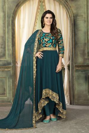 Add This New Shade To Your Wardrobe With This Designer High Low Patterned Suit In Teal Blue Color Paired With Teal Blue Colored Bottom And Dupatta. Its Top And Dupatta Are Georgette Based Paired With Santoon Bottom.