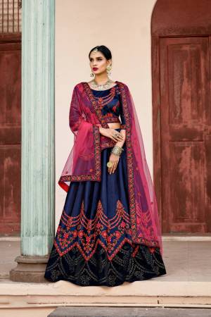 Enhance Your Personality In This Heavy Designer Lehenga Choli In Navy Blue Color Paired With Contrasting Dark Pink Colored Dupatta. Its Blouse And Lehenga Are Satin Based Paired With Net Fabricated Dupatta. 
