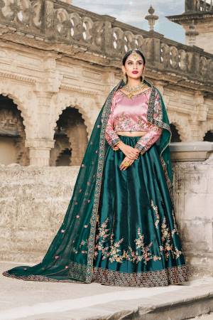 You Will Definitely Earn Lots Of Compliments Wearing This Designer Lehenga Choli In Baby Pink Colored Blouse Paired With Contrasting Teal Green Colored Lehenga And Dupatta. Its Blouse And Lehenga Are Satin Based Paired With Net Fabricated Dupatta. Buy Now.