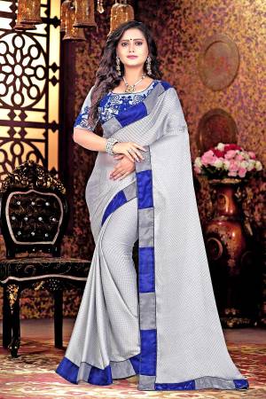 Flaunt Your Rich And Elegant Taste Wearing This Designer Saree In Grey Color Paired With Grey Colored Blouse. This Saree Is Fabricated On Satin Cheks Paired With Net And Satin Fabricated Blouse. Its Blouse Has Heavy Thread Work Making The Saree Attractive. 