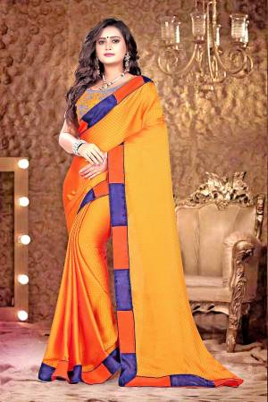 Bright And Visually Appealing Color Is Here With This Designer Saree In Orange Color Paired With Contrasting Blue Colored Blouse. This Saree Is Fabricated On Satin Checks Paired With Net And Satin Fabricated Blouse. Buy This Saree Now. 