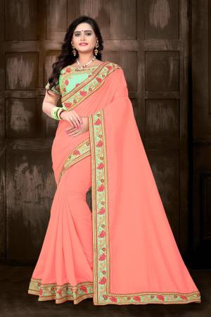 Celebrate This Festive Season With Designer Saree In Bright Color Pallete. This Pretty Saree Is In Dark Peach Color Paired With Contrasting Light Green Colored Blouse. This Saree And Blouse Are Silk Based Which Also Gives An Enhanced Look To Your Personality. 