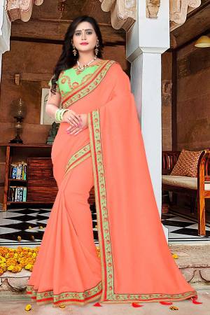 Add This Very Pretty And Attractive Looking Saree To Your Wardrobe For Upcoming Festive And Wedding Season. This Saree Is In Peach Color Paired With Light Green Colored Blouse. This Saree And Blouse Are Silk Based Which Give A Rich And Beautiful Look To Your Personality. 