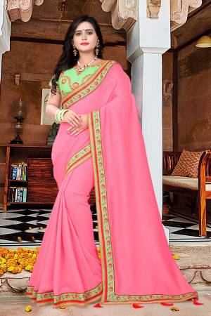 Add This Very Pretty And Attractive Looking Saree To Your Wardrobe For Upcoming Festive And Wedding Season. This Saree Is In Pink Color Paired With Light Green Colored Blouse. This Saree And Blouse Are Silk Based Which Give A Rich And Beautiful Look To Your Personality. 