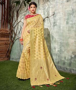 This subtle color of bliss- yellow  saree adorned with handwork buttis and tassels in woven silk fabric is sure to add a touch of everlasting bliss.