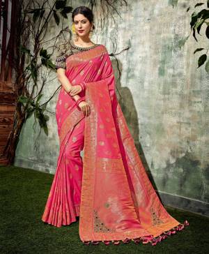Welcome the wedding festivities in this rich and vibrant pink weaved silk saree . Add flowers to your hairdo to complete the look. 