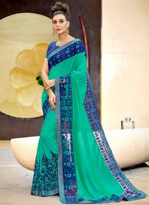 This Festive Season, Have A Subtle, Simple And Elegant Look Wearing This Saree In Sea Green Color Paired With Contrasting Royal Blue Colored Blouse. This Saree Is Fabricated On Chiffon Silk Paired With Art Silk Fabricated Blouse. 