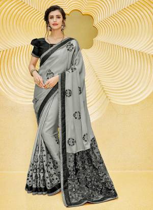 Flaunt You Rich And Elegant Taste Wearing This Designer Saree In Grey Color Paired With Paired With Black Colored Blouse. This Saree IS Fabricated On Satin Georgette Paired With Art Silk Fabricated Blouse. 