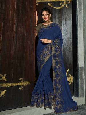 You can this amazing saree and look pretty like never before. wearing this Navy Blue color silk fabrics saree. this gorgeous saree featuring a beautiful mix of designs. look gorgeous at an upcoming any occasion wearing the saree. Its attractive color and designer heavy embroidered design, Flower patch design, zari resham work, stone design, beautiful floral design work over the attire & contrast hemline adds to the look. Comes along with a contrast unstitched blouse.