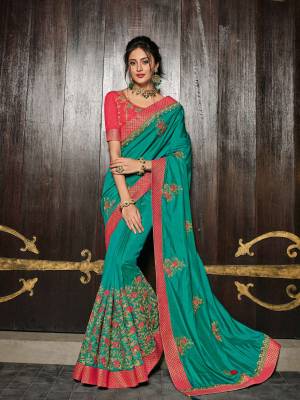 Flaunt your gorgeous look wearing this Turquoise Blue color two tone silk saree. Ideal for party, festive & social gatherings. this gorgeous saree featuring a beautiful mix of designs. Its attractive color and designer heavy embroidered design, Flower patch design, zari resham work, stone design, beautiful floral design work over the attire & contrast hemline adds to the look. Comes along with a contrast unstitched blouse.