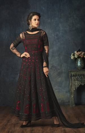 For A Bold And Beautiful Look, Grab This Designer Floor Length Suit In Black And Red Color Paired With Black Colored Bottom And Dupatta. Its Top Is Net Based Paired With Santoon Bottom And Chiffon Dupatta. Buy Now.