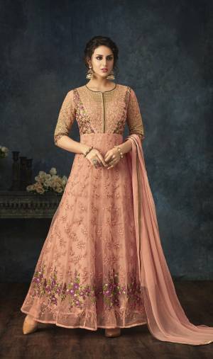 A Must Have Shade In Every Womens Wardrobe Is Here With This Designer Floor Length Suit In Peach Color Paired With Peach Colored Bottom And Dupatta. Its Top Is Fabricated On Net Paired With Santoon Bottom And Chiffon Dupatta. Buy It Now.