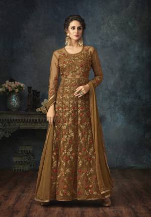 New Shade Is Here To Add Into Your Wardrobe With This Designer Floor Length Suit In Brown Color Paired With Brown Colored Bottom And Dupatta. Its Top Is Net Based With Heavy Embroidery Paired With Santoon Bottom And Chiffon Dupatta. All Its Fabric Ensures Superb Comfort All Day Long. 