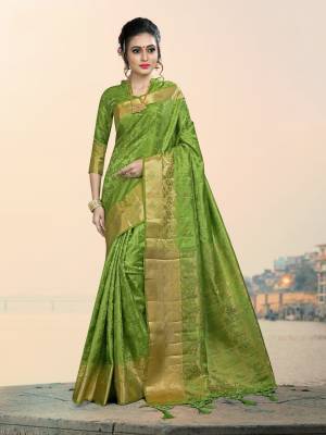Add This Lovely Attractive Looking Saree In Light Green Color Paired With Light Green Colored Blouse. This Lovely Saree And Blouse Are Silk based Which Give A Rich And Elegant Look To Your Personality. 