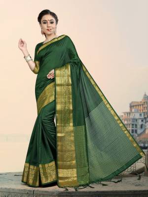 Add This Lovely Attractive Looking Saree In Dark Green Color Paired With Dark Green Colored Blouse. This Lovely Saree And Blouse Are Silk based Which Give A Rich And Elegant Look To Your Personality. 