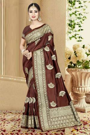 Enhance Your Personality In This Designer Silk Based Saree In Brown Color Paired With Brown Colored Blouse. Its Elegant Color And Rich Fabric Will Earn You Lots Of Compliments From Onlookers.