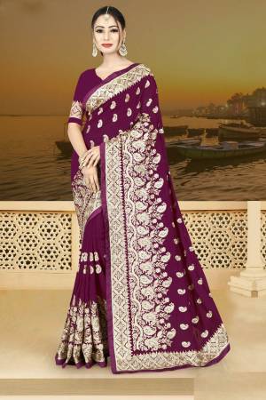 Bright Color Gives An Attractive Look To Your Personality, So Grab This Beautiful Designer Saree In Wine Color Paired With Wine Colored Blouse. This Saree And Blouse Are Silk Based Beautified With Heavy Jari Work. Buy Now.