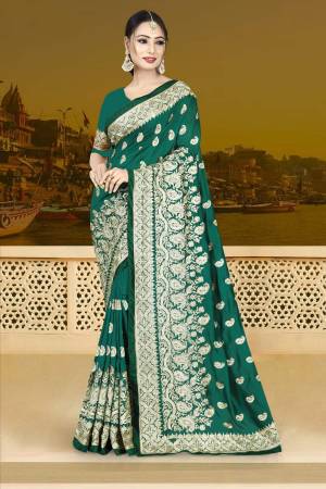 Bright Color Gives An Attractive Look To Your Personality, So Grab This Beautiful Designer Saree In Teal Green Color Paired With Teal Green Colored Blouse. This Saree And Blouse Are Silk Based Beautified With Heavy Jari Work. Buy Now.