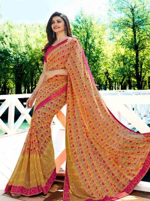 Celebrate This Festive Season Wearing This Designer Printed Saree In Yellow Color Paired With Contrasting Rani Pink Colored Blouse. This Saree Is Georgette Based Paired With Art Silk Fabricated Blouse. It Has Very Pretty Small Prints All Over The Saree. 