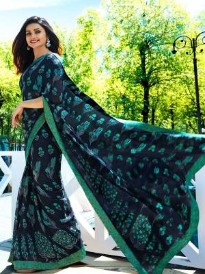 Enhance Your Personality Wearing This Designer Saree In Navy Blue Color Paired With Contrasting Sea Green Colored Blouse. This Saree Is Georgette Based Paired With Art Silk Fabricated Blouse. Buy Now.