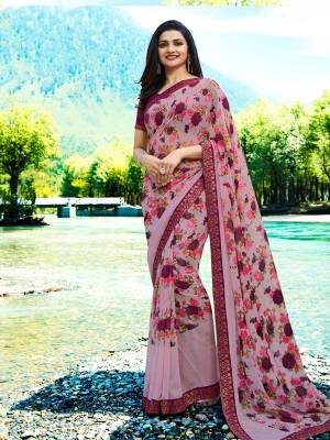 You Will Definitely Earn Lots Of Compliments Wearing This Pretty Saree In Mauve Color Paired With Purple Colored Blouse. This Saree Is Georgette Based Paired With Art Silk Fabricated Blouse. It Has Very Pretty Floral Prints All Over It. 