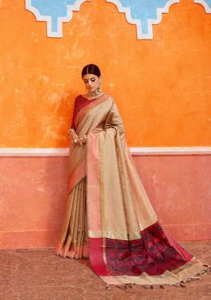 Flaunt Your Rich And Elegant Taste Wearing This Silk Based Saree In Beige Color Paired With Red Colored Blouse. This Saree And Blouse Are Fabricated On Handloom Art Silk Beautified With Weave Over Its Pallu.