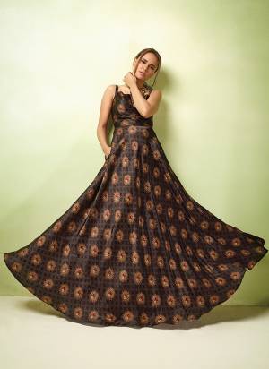 Enhance Your Personality Wearing This Designer Readymade Gown In Brown Color Paired With Cream Colored Top. This Gown IS Fabricated On Printed Satin Paired With Orgenza Fabricated Embroidered Top. 